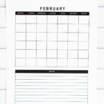 Close-up vertical view of the undated February calendar with a simple grid and a bold black Notes header above the lined notes area, shown against a white tile background.