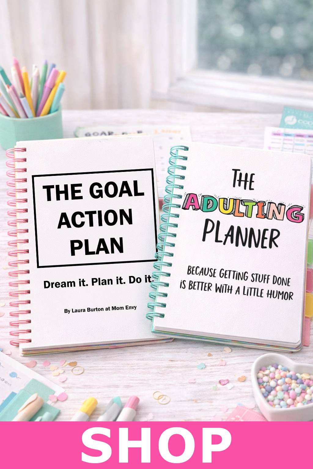 Digital shop image featuring The Goal Action Plan planner and The Adulting Planner surrounded by pastel stationery supplies on a bright desk workspace promoting Mom Envy planners and printable products