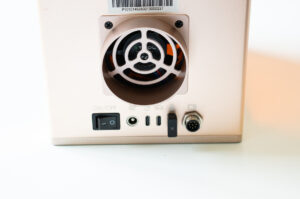 Close-up of the rear fan, power switch, and connection ports on the xTool F2 laser engraver.