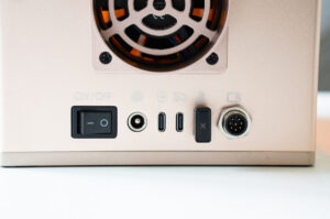 Close-up of the xTool F2 rear connection panel with power switch, USB-C ports, and rotary attachment port.
