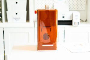 Full front view of the xTool F2 desktop laser engraver displayed on a craft table.