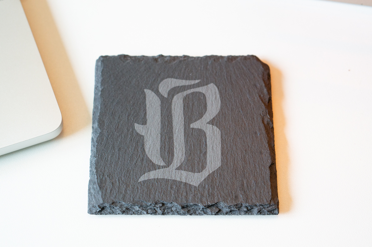 Slate coaster engraved with a decorative letter "B" monogram using the xTool F2 laser engraver.