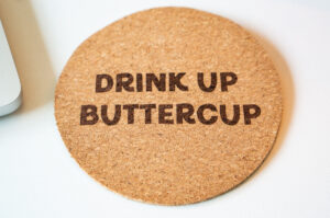 Cork coaster engraved with the phrase "Drink Up Buttercup" using the xTool F2 laser engraver.