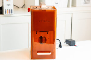 The xTool F2 laser engraver displayed on a craft table after setup and testing.