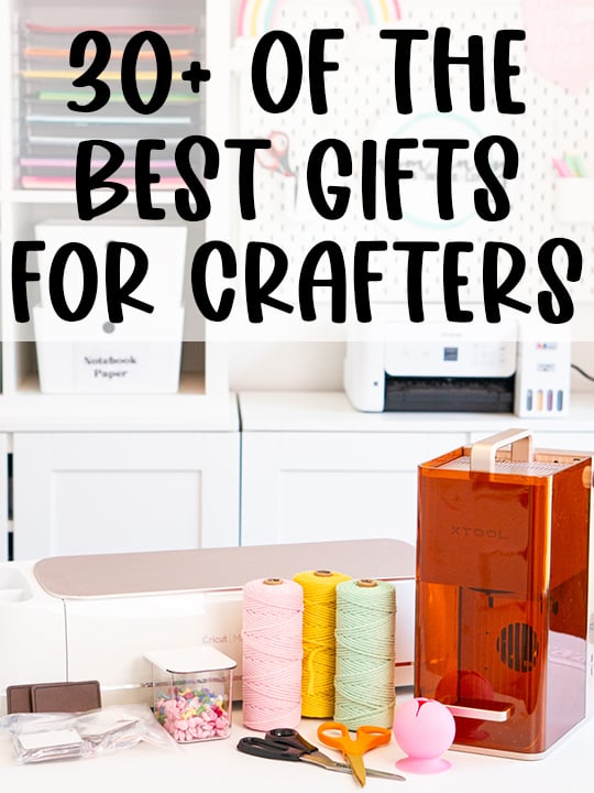 Pinterest-style graphic for a crafter gift guide featuring a bright craft room and a table filled with crafting supplies and machines, including a Cricut cutting machine, xTool laser machine, colorful spools of twine, scissors, craft blanks, a small storage container, and a pink vinyl scrap collector. Large black text across the top reads