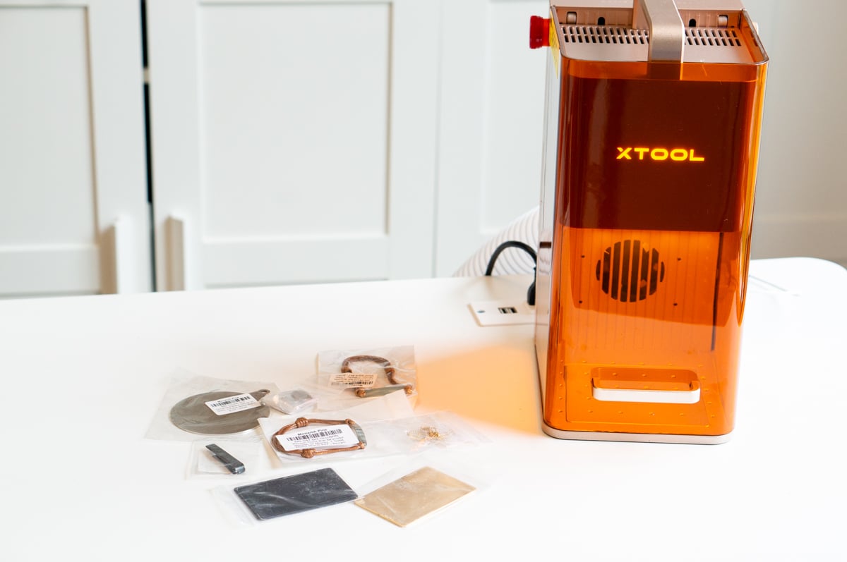 xTool F2 laser engraver with metal jewelry blanks ready for custom engraving