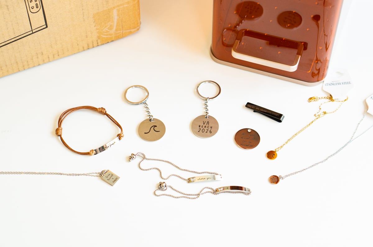 Collection of personalized jewelry and keychains laser engraved with handwriting, text and custom designs