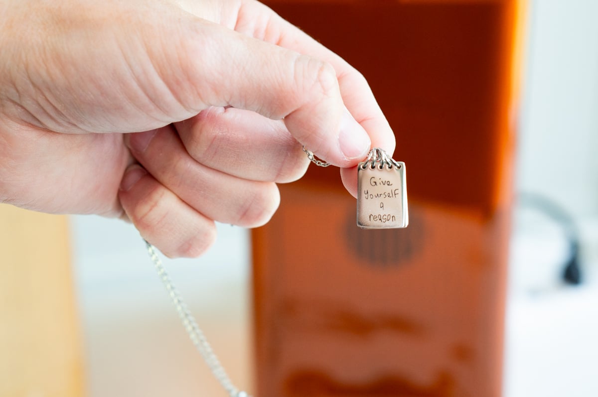 Personalized necklace engraved with the handwritten phrase Give yourself a reason using the xTool F2