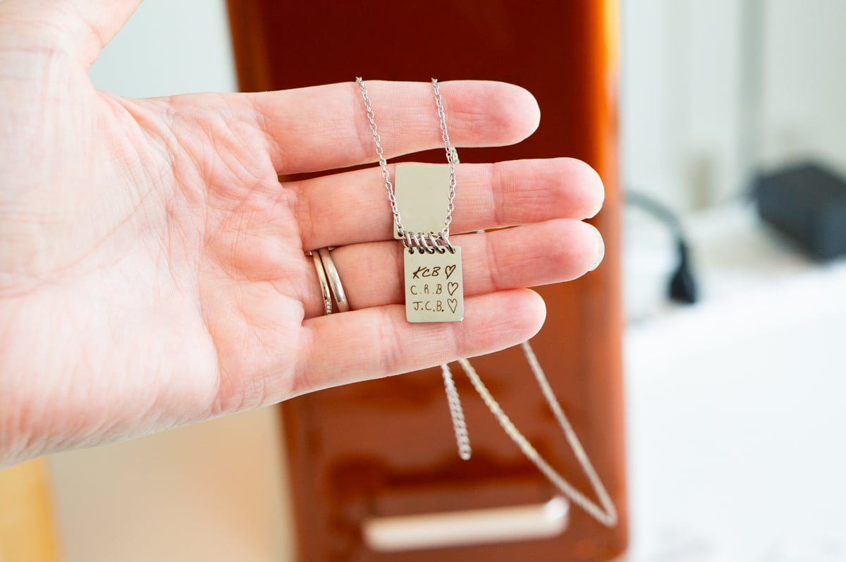 Custom necklace engraved with handwritten initials and hearts using the xTool F2 laser engraver