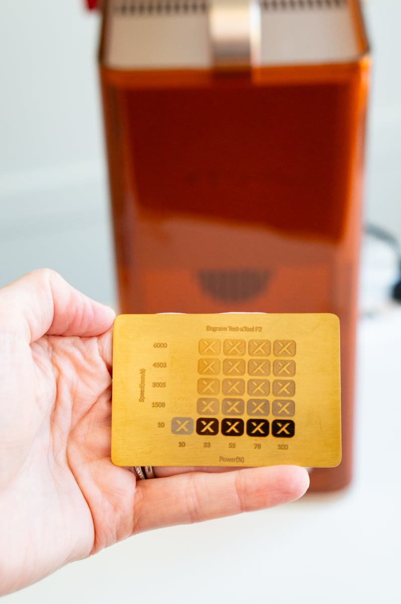 xTool F2 engraving test on brass comparing laser power and speed settings