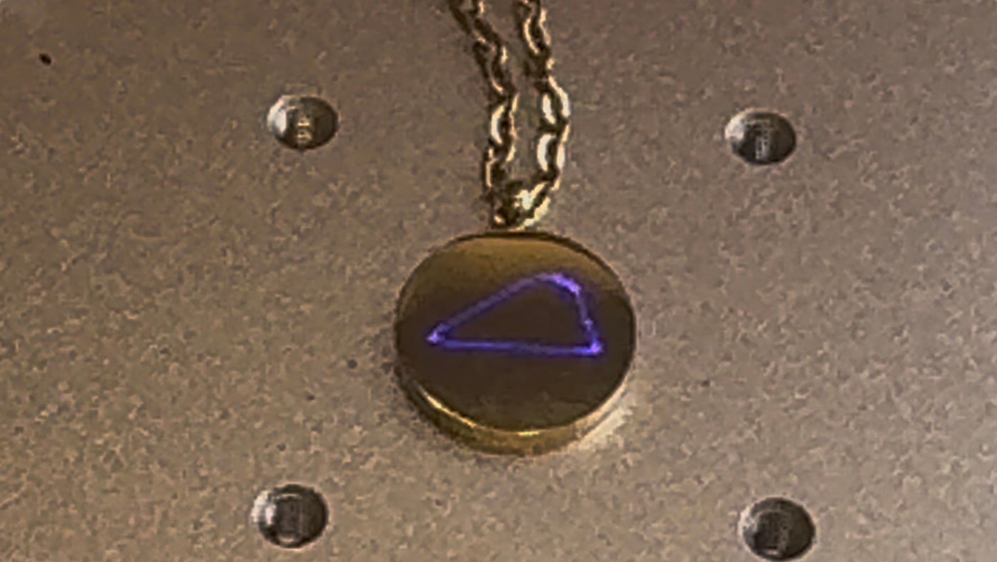 This image shows an example of xTool's F2 framing on a round gold pendant. 
